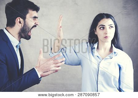 Couple Having Arguement At Home On Dark Background