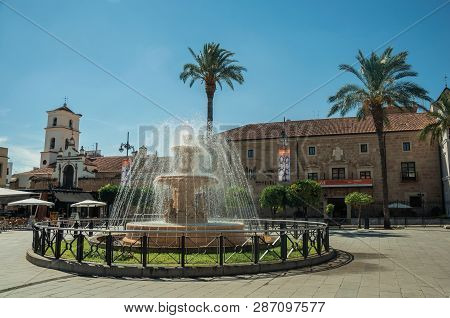 Fountain On A Square In Front Of Buildings At Merida