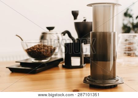 Aeropress, Steel Kettle, Electronic Scales, Manual Grinder, Coffee Beans,filters On Wooden Table. Al