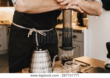Professional Barista Preparing Coffee In Aeropress, Alternative Coffee Brewing Method. Hands On Aero