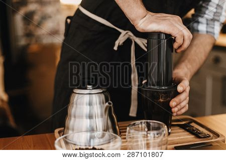 Professional Barista Preparing Coffee In Aeropress, Alternative Coffee Brewing Method. Hands On Aero