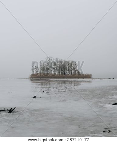 Island On Ice Covered Lake