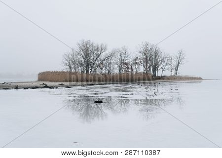 Island On Ice Covered Lake
