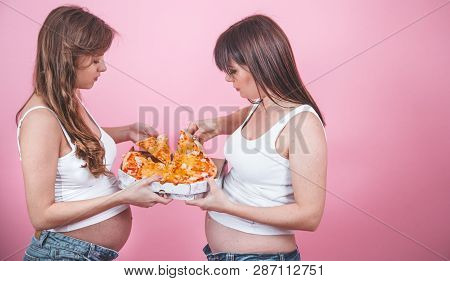 Nutrition Concept, Pregnant Women Eating Pizza On A Pink Background