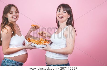 Nutrition Concept, Pregnant Women Eating Pizza On A Pink Background