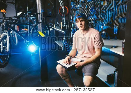 Young Handsome Stylish Man In A Cap Snapback And With A Tattoo Small Business Owner Selling A Bicycl