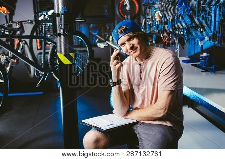 Young Handsome Stylish Man In A Cap Snapback And With A Tattoo Small Business Owner Selling A Bicycl