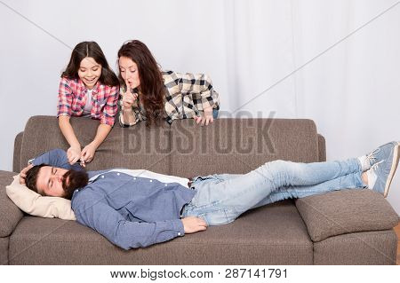 Family Prank. Little Girl With Mother Cut Fathers Beard. Happy Family At Home. Bearded Man Relax On 