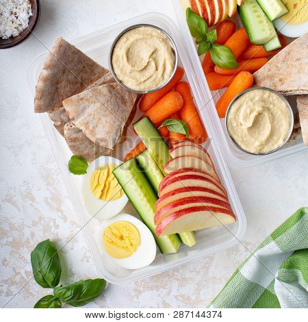 Healthy And Nutricious Lunch Or Snack Boxes To Go With Hummus And Pita, Eggs And Vegetables