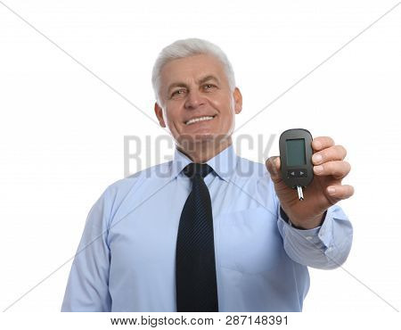 Senior Man Holding Glucometer On White Background. Diabetes Control