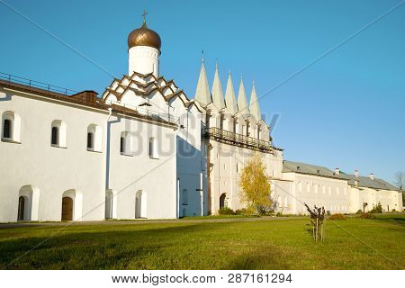 Belfry And Pokrovskaya Church Of The Old Tikhvinsky Uspensky Monastery On A Sunny October Day. Tikhv