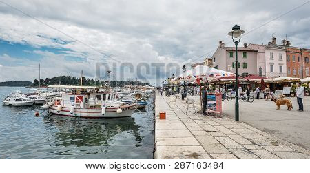 Rovinj, Croatia - May 22, 2018: People Walking Near Pier And Yachts In Coastal Town Of Rovinj, Istri