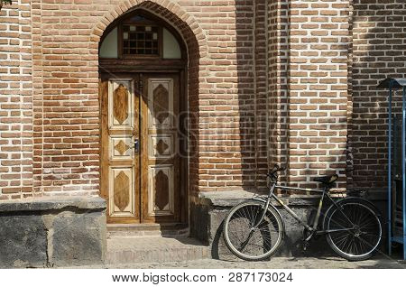 Ardabil,iran- September 26, 2018: Bicycle Near The Brick Wall Of The Garden, Near Tomb Of Sheikh Saf