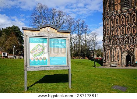 Lichfield, Uk - March 13, 2018 - Cathedral Plan And Service Times Sign Outside With Part Of The Cath