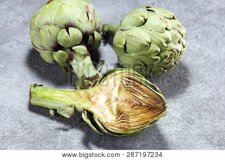 Artichokes On Rustic Background. Fresh Organic Artichoke Flower Set