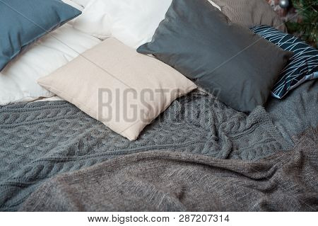 Pillows And Blankets Are On The Bed.