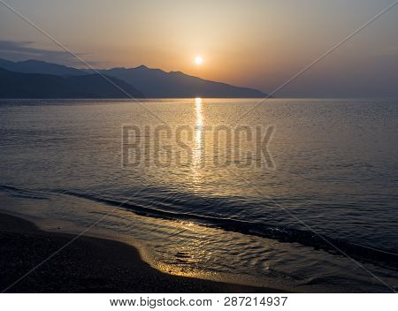 Waves And Beautiful Sunset On The Greek Island Evia (euboea) In The Aegean Sea