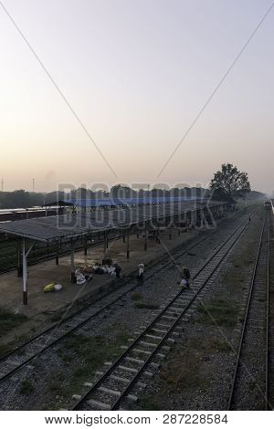 Thazi, Myanmar - 23 November, 2018: Vertical Picture Of People Walking On The Rails At Thazi Train S