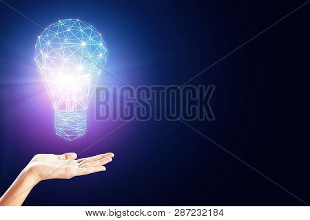 Female Hand Hoding Glowing Polygonal Lamp On Dark Background. Innovation And Idea Concept