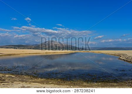 Dry Land As In The Desert With Small Lake - Image/ Beautiful Nature Landscape