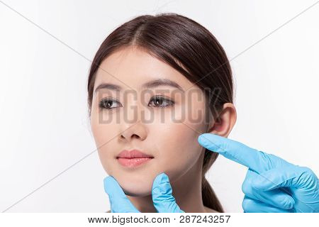 Surgery Concept. Asian Beautiful Woman Doing Facial Surgery. The Doctor Pointed Out The Structure Of