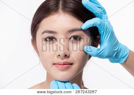 Surgery Concept. Asian Beautiful Woman Doing Facial Surgery. The Doctor Pointed Out The Structure Of