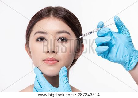 Surgery Concept. The Doctor Cosmetologist Makes The Rejuvenating Facial Injections Procedure For Tig