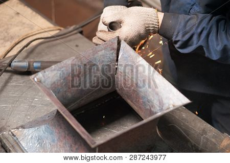 Close Up Of Blacksmith Soldering A Metal Plates To Make A Metal Stand. The Blacksmith In White Black