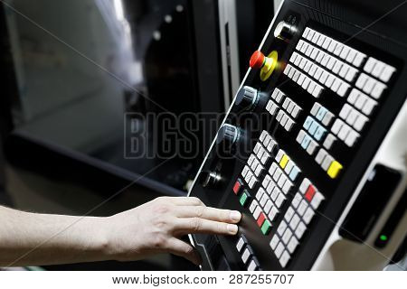 Cnc Lathe Machine Operator At Work. Selective Focus.