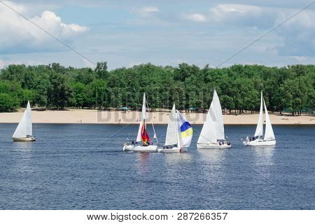 Regatta On Lake River Sailing Yachts Boats With White Sails And Gennakers, Reflected Sky In Water