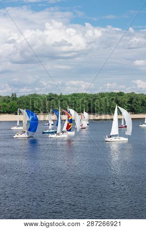 Regatta Of Lake River Sailing Yachts Boats With White And Multicolored Sails, Reflected Sky Clouds I