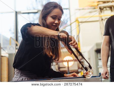 A Glassblower Student Tries To Make A Flower Out Of Glass