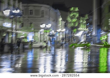 Late Evening In The Deserted City, Lonely Pedestrians Rush Home, Abstract Blurred Background. Bright
