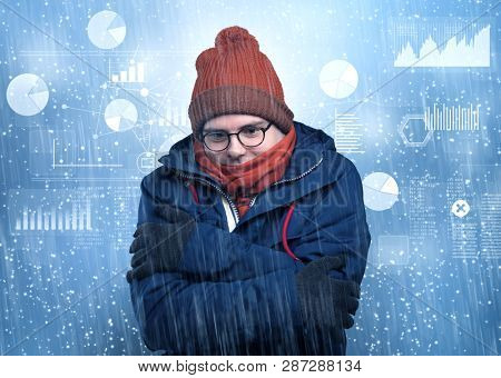 Young businessman shivering with graphs, reports and chart concept