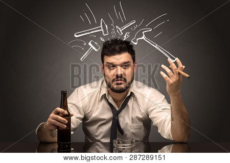 Young drunk disappointed man with hangover concept