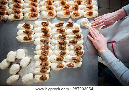 Baker Make Buns With Filling Of Jam And Condensed Milk  From Dough