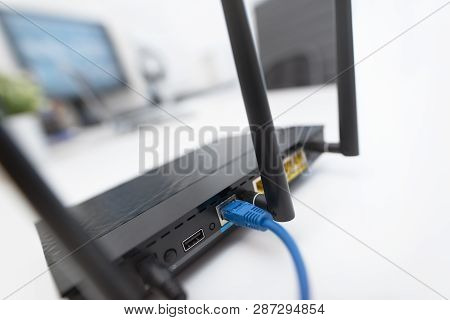 Modern Dual Band Wireless Router. Man Working In The Background. Fast And Wireless Internet Concept.
