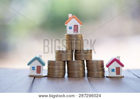 Mini House On Stack Of Coins,money And House,  Mortgage, Savings Money For Buy House And Loan To Bus