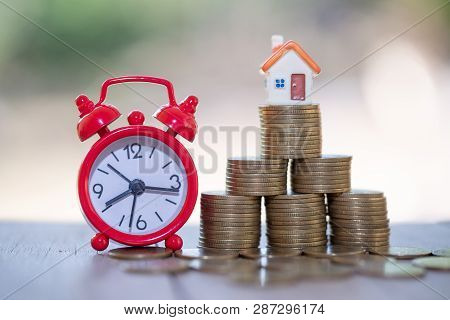 Mini House On Stack Of Coins,money And House,  Mortgage, Savings Money For Buy House And Loan To Bus