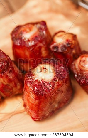 ox tails griiled and smoked on wooden board