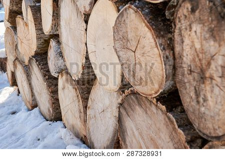 Abstraction Wooden Chocks For Home Heating Stacked On Each Other Under A Canopy In Winter Snow
