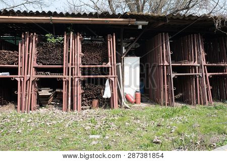 Scaffolding Storage Area In Outdoor, Detail Of Stacks Of Pipes, Poles, Used And Rusty Staffolding
