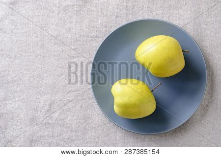 Ugly Fresh Food Concept With Fresh Misshapen Golden Apples On A Blue Plate In A Concept Of Aesthetic