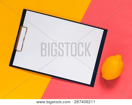 Creative Geometric Flat Lay Background. Blank Clip Board, Yellow And Pink Color Papper. Minimalistic