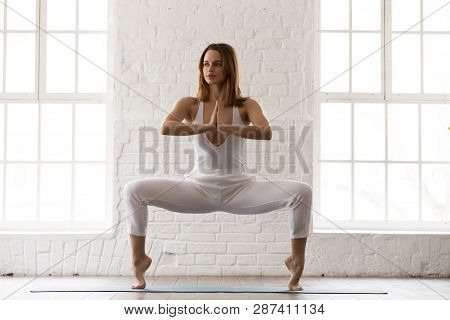 Attractive Woman Standing In Goddess Pose, Sumo Squat, Yoga Exercise