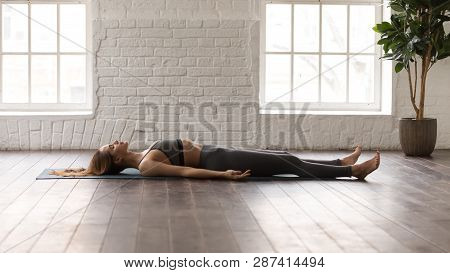 Woman Practicing Yoga, Lying In Savasana, Dead Body Pose