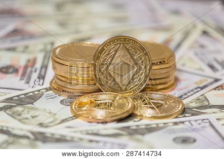 Business Concept Of Crypto Currency. Golden Etherium Coin On Us Dollars Close Up.