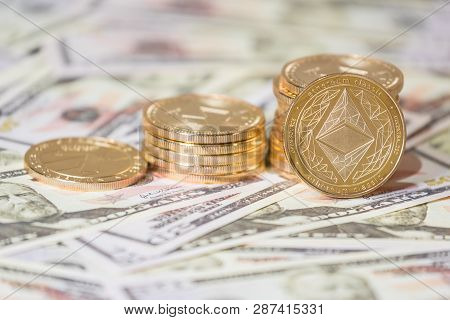Business Concept Of Crypto Currency. Golden Etherium Coin On Us Dollars Close Up.