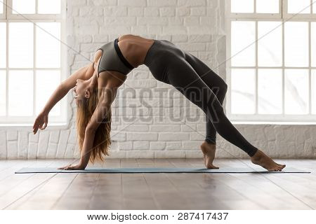 Beautiful Woman Practicing Yoga, Standing In Wild Thing Pose, Camatkarasana