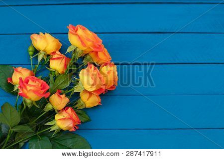 Background Of A Bouquet Of Beautiful Fresh Vivid Orange Roses Tinged With Red For Celebrating Valent